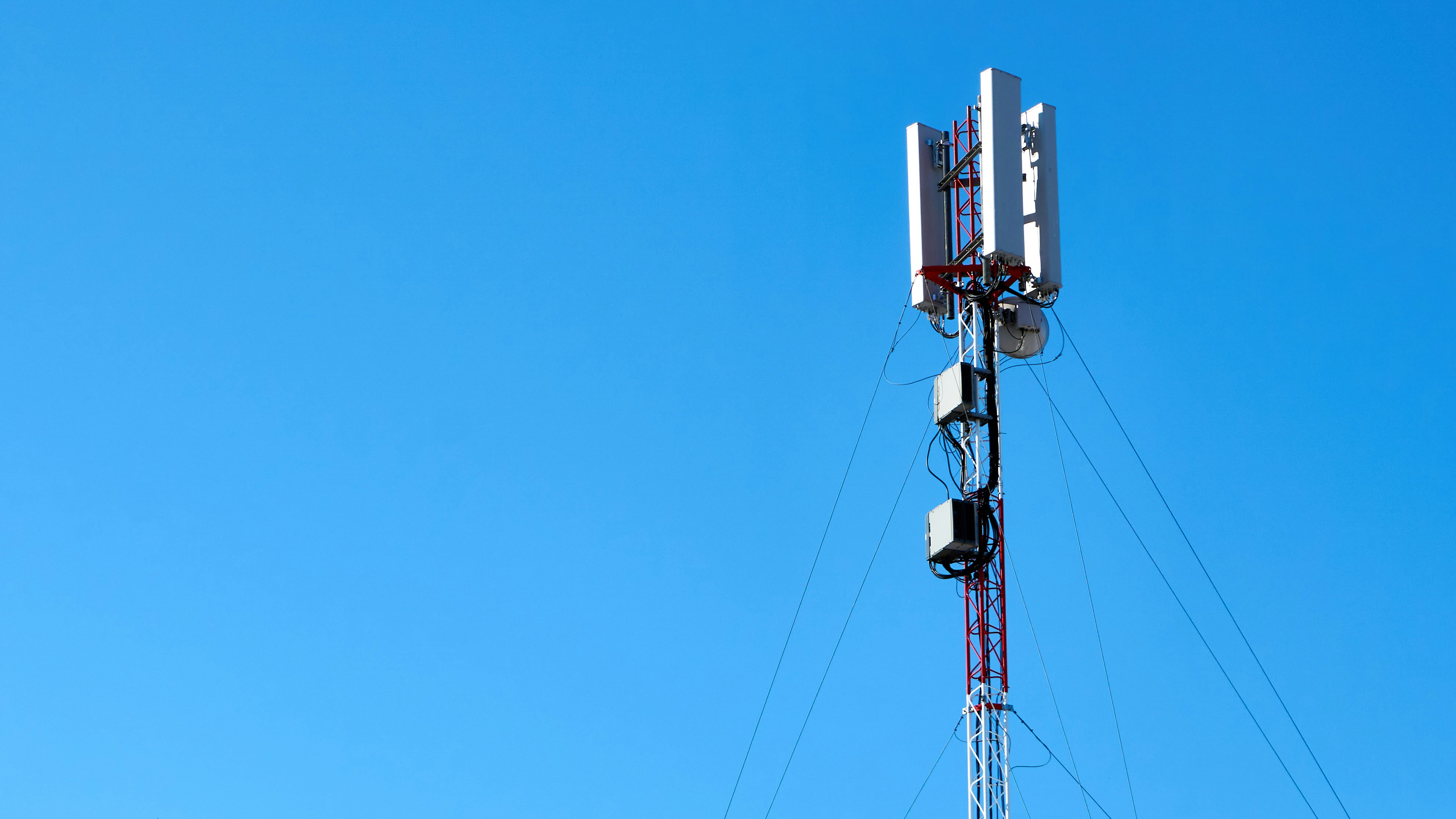 A communications tower against a clear blue sky